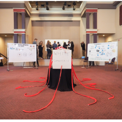 Photograph of convening in a ballroom with interactive components and whiteboards