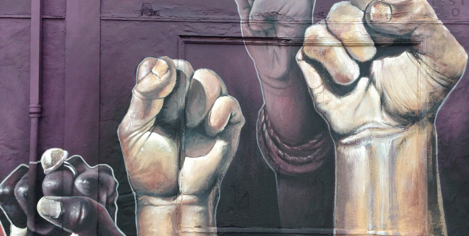 Photo of mural depicting raised fists