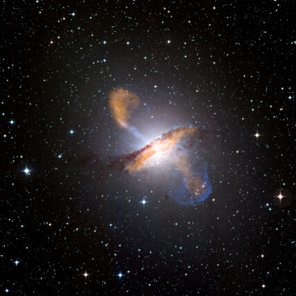 This image of Centaurus A shows a spectacular new view of a supermassive black hole's power. Jets and lobes powered by the central black hole in this nearby galaxy are shown by submillimeter data (colored orange) from the Atacama Pathfinder Experiment (APEX) telescope in Chile and X-ray data (colored blue) from the Chandra X-ray Observatory. Visible light data from the Wide Field Imager on the Max-Planck/ESO 2.2 m telescope, also located in Chile, shows the dust lane in the galaxy and background stars. The X-ray jet in the upper left extends for about 13,000 light years away from the black hole. The APEX data shows that material in the jet is travelling at about half the speed of light.